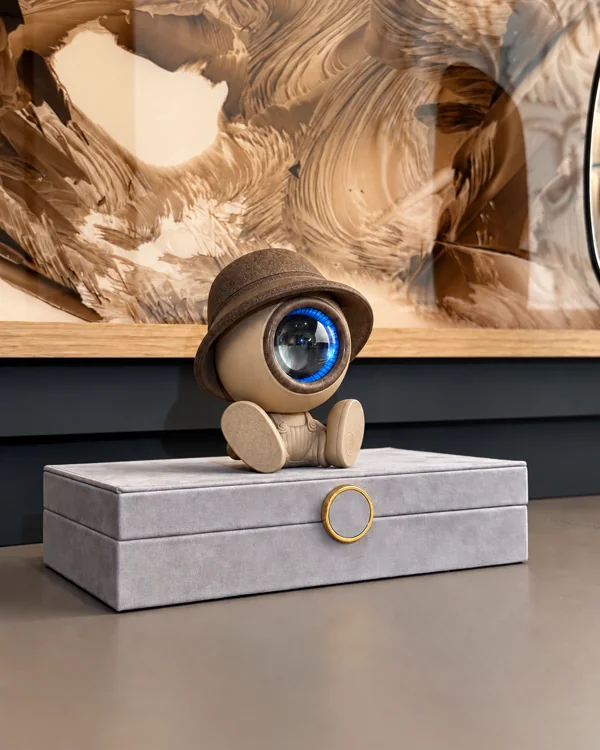 NORAA Home Edition, Earth Mineral — seated figure on a grey box, prototype photograph